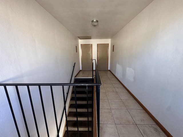 stairway featuring tile patterned floors