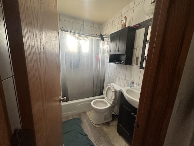 full bathroom with shower / tub combo with curtain, toilet, tile walls, vanity, and hardwood / wood-style floors