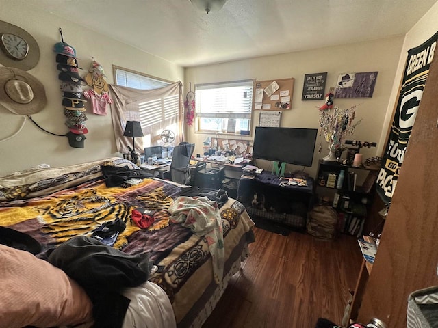 bedroom with dark hardwood / wood-style flooring