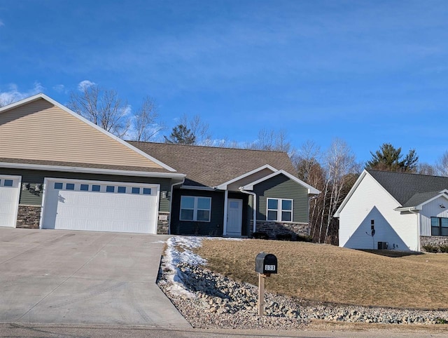 view of front of house featuring a garage and a front lawn