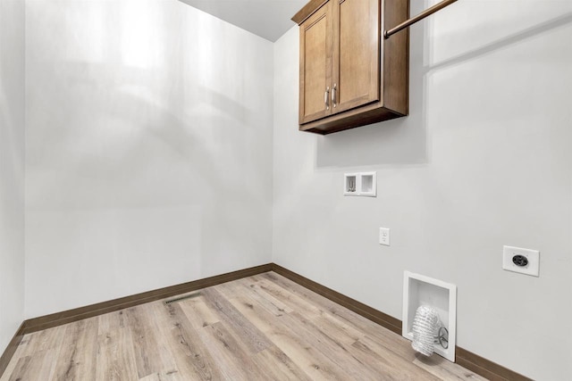 clothes washing area with cabinets, hookup for a washing machine, hookup for an electric dryer, and light wood-type flooring