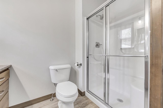 bathroom featuring walk in shower, vanity, and toilet