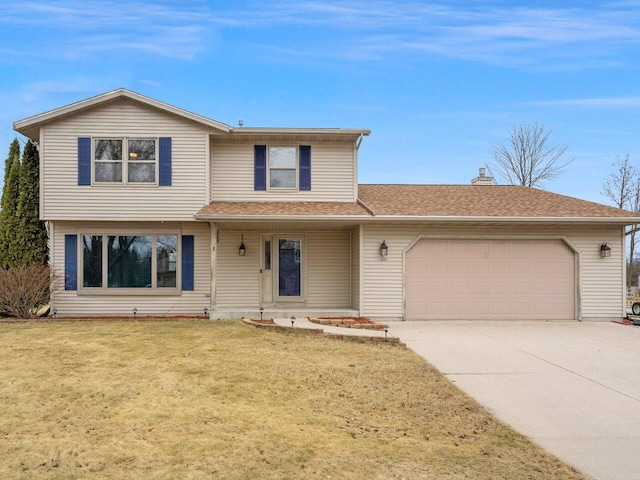 view of property with a garage and a front lawn