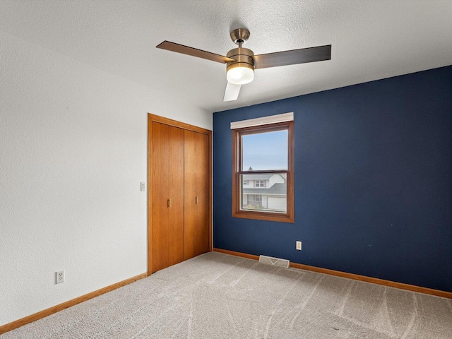 carpeted empty room with ceiling fan