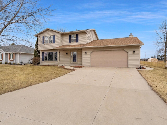 front of property featuring a garage and a front lawn