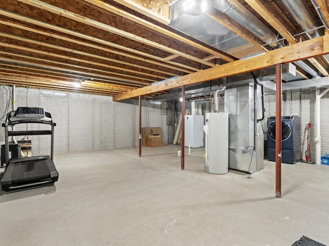 basement with brick wall, washer and clothes dryer, heating unit, and gas water heater