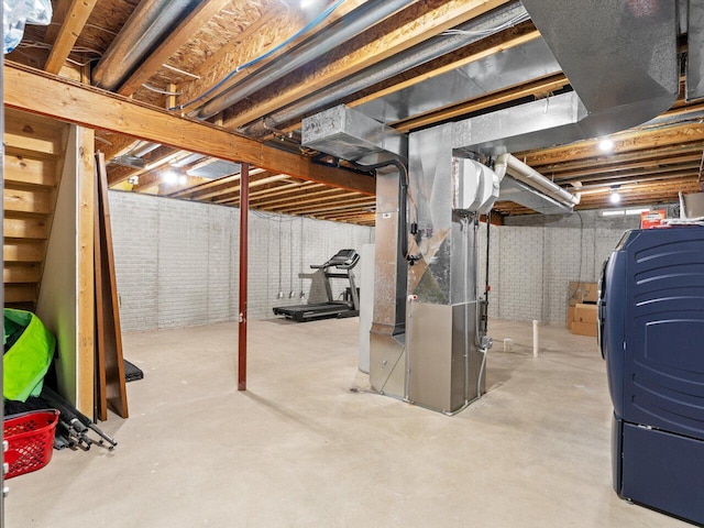 basement featuring brick wall and heating unit