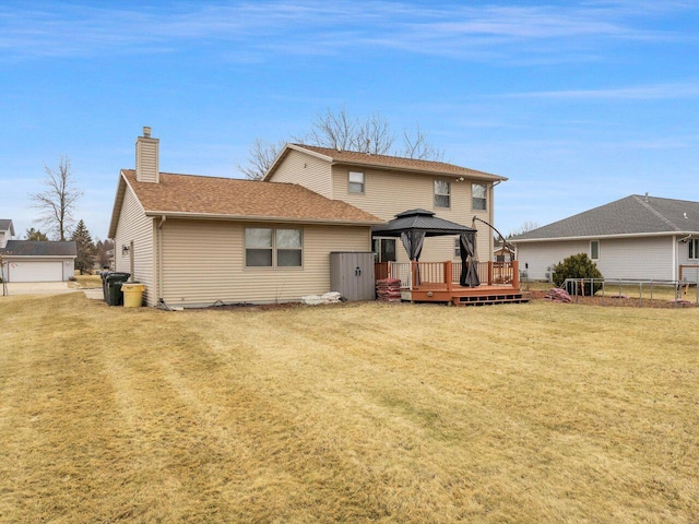 back of house with a gazebo and a yard