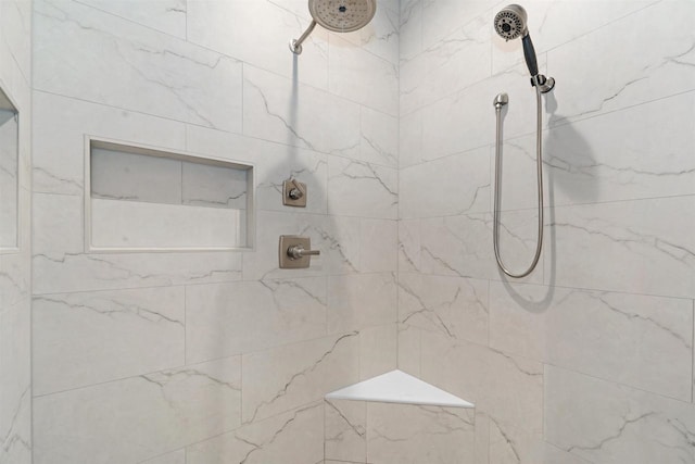 bathroom with a tile shower