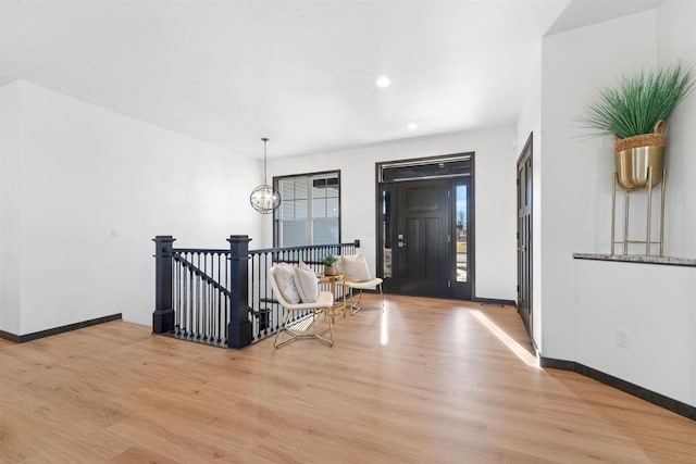 foyer with a chandelier and light hardwood / wood-style floors