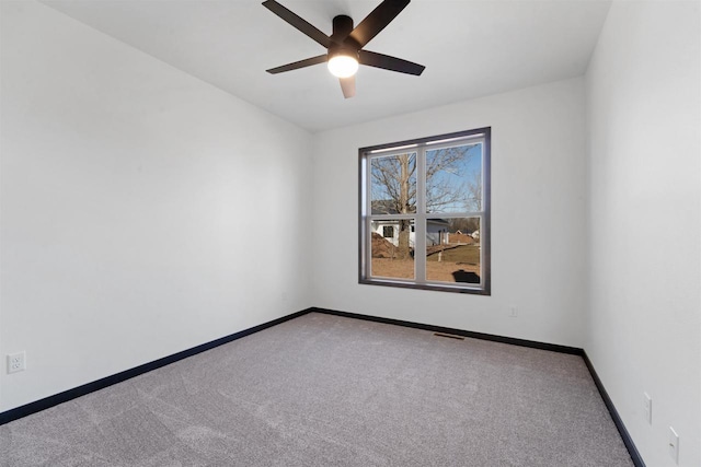 spare room with ceiling fan and carpet flooring