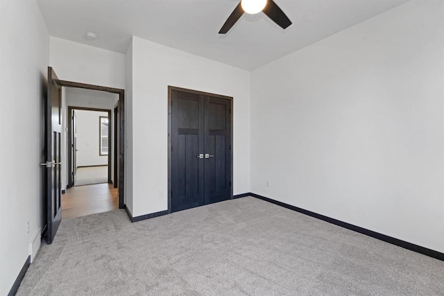 unfurnished bedroom with light carpet and ceiling fan