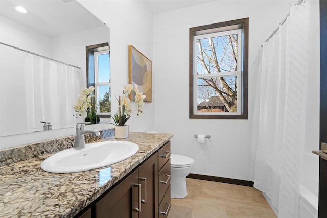 bathroom with a shower with curtain, vanity, and toilet