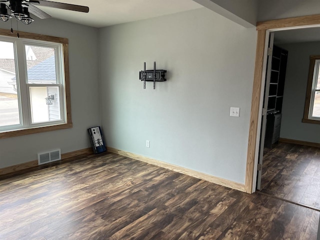 unfurnished room with ceiling fan and dark hardwood / wood-style floors