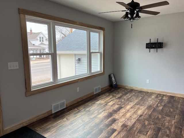 unfurnished dining area featuring dark wood-type flooring and ceiling fan