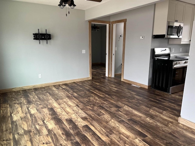 kitchen featuring white cabinetry, ceiling fan, stainless steel appliances, and dark hardwood / wood-style floors