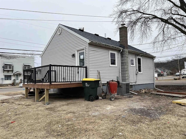 rear view of property featuring a deck and central air condition unit