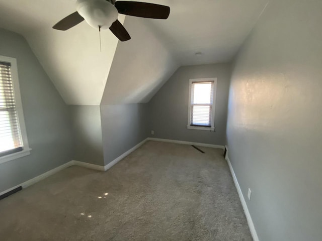 bonus room with carpet floors and vaulted ceiling