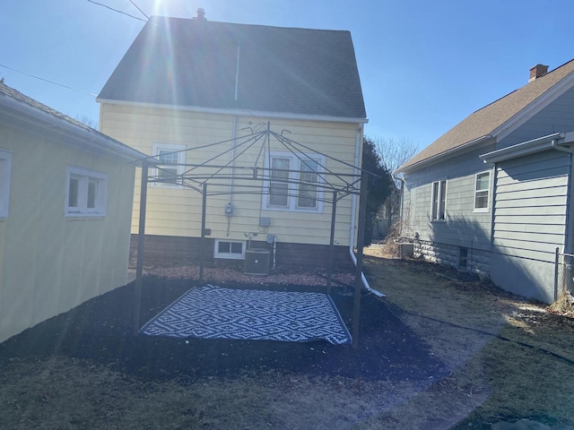 rear view of property featuring central AC