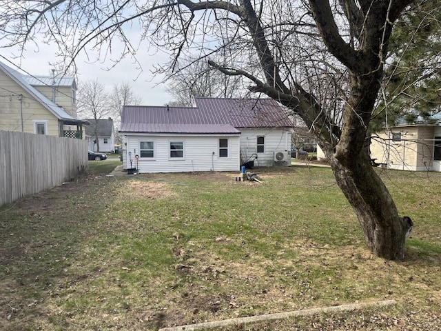 428 Pine St, Tomah, WI 54660 - back of house with a lawn, fence, and metal roof