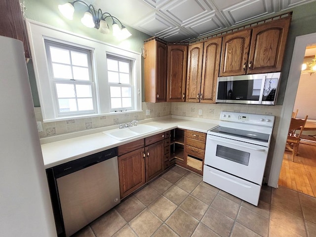 kitchen with stainless steel appliances, sink, and decorative backsplash