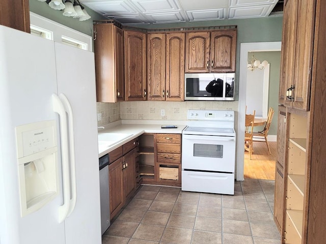 kitchen featuring tasteful backsplash, stainless steel appliances, sink, and light tile patterned floors