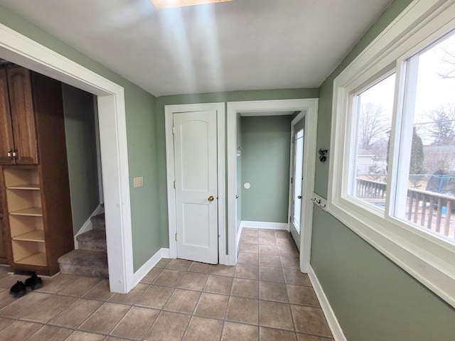 hall with light tile patterned flooring