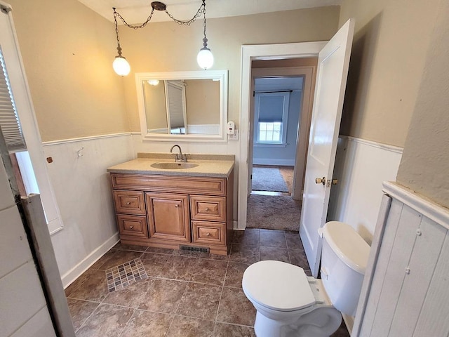 bathroom with vanity, tile patterned floors, and toilet