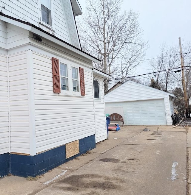 view of side of property with a garage and an outdoor structure