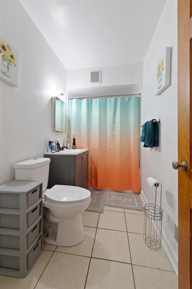 bathroom featuring tile patterned flooring, toilet, and walk in shower