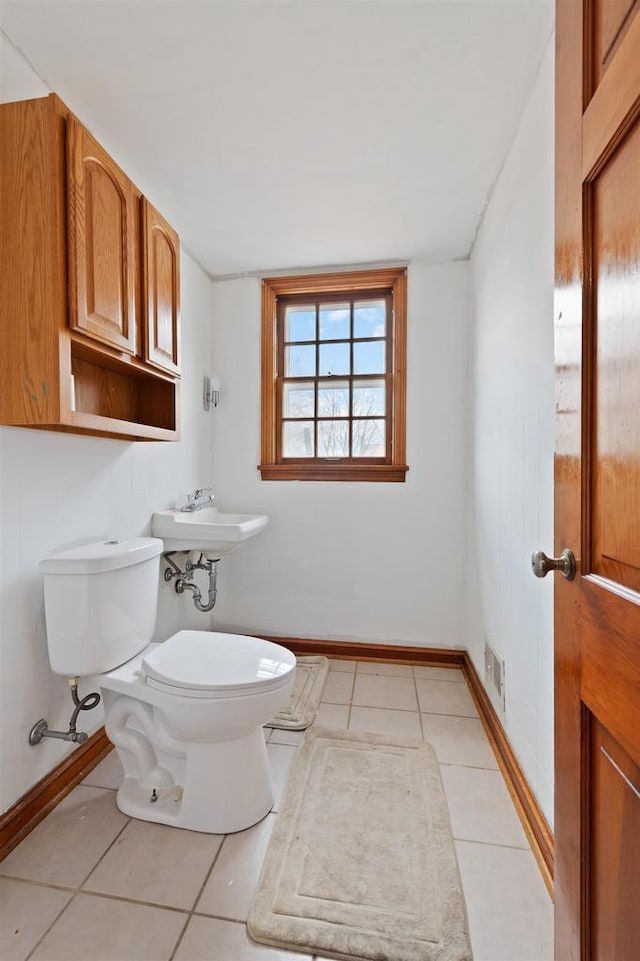 bathroom featuring sink, tile patterned floors, and toilet