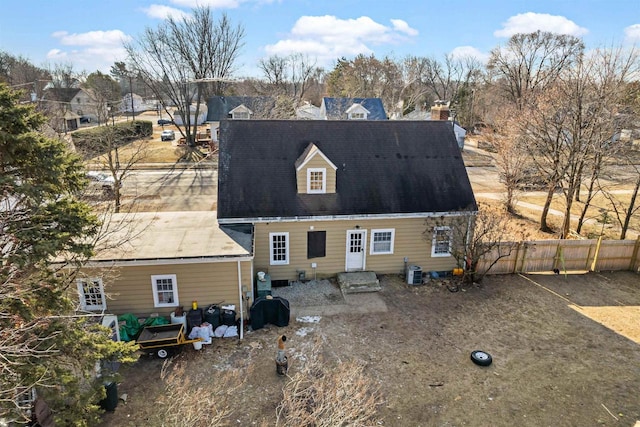 back of house with central AC