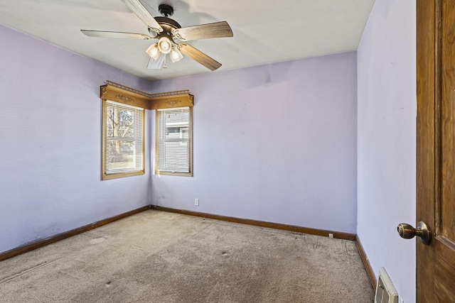 empty room featuring ceiling fan and light colored carpet