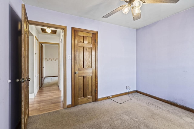 unfurnished bedroom with light colored carpet and ceiling fan