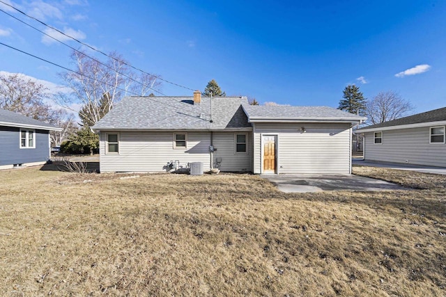 back of house with a yard, central AC unit, and a patio area