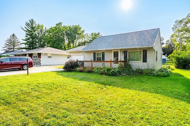 ranch-style home featuring a garage and a front lawn