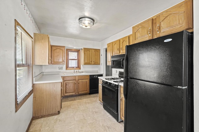 kitchen featuring sink and black appliances