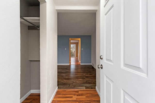 hallway with dark wood-type flooring