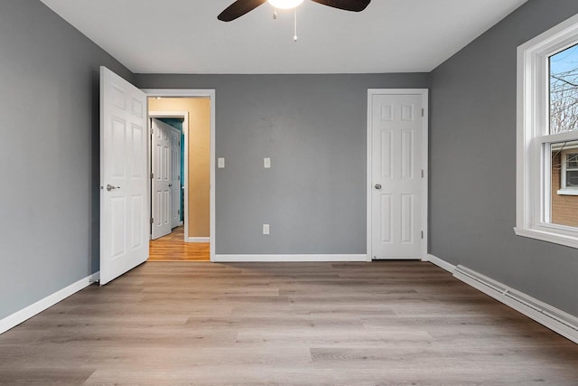 unfurnished bedroom featuring ceiling fan and light wood-type flooring