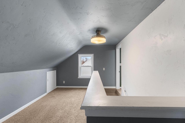 bonus room featuring lofted ceiling and carpet flooring