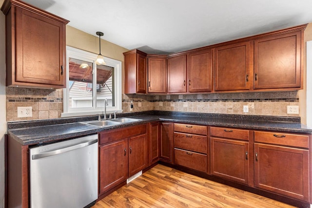 kitchen featuring dishwasher, sink, decorative backsplash, hanging light fixtures, and light hardwood / wood-style floors