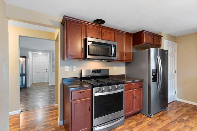 kitchen featuring hardwood / wood-style flooring and stainless steel appliances