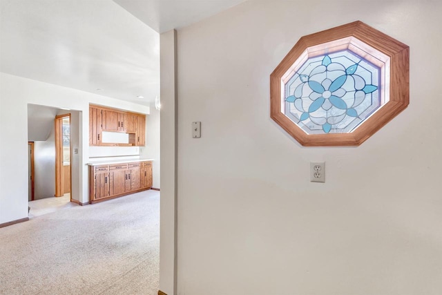 hallway featuring light carpet