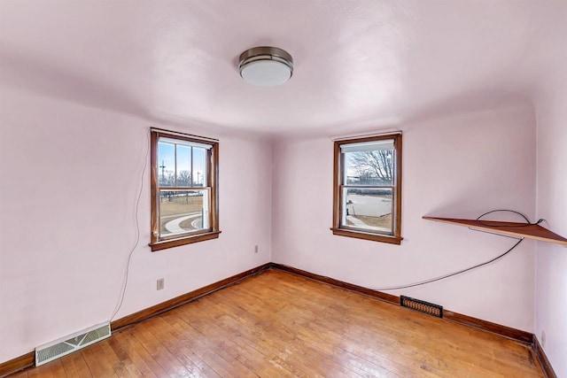 spare room with hardwood / wood-style floors