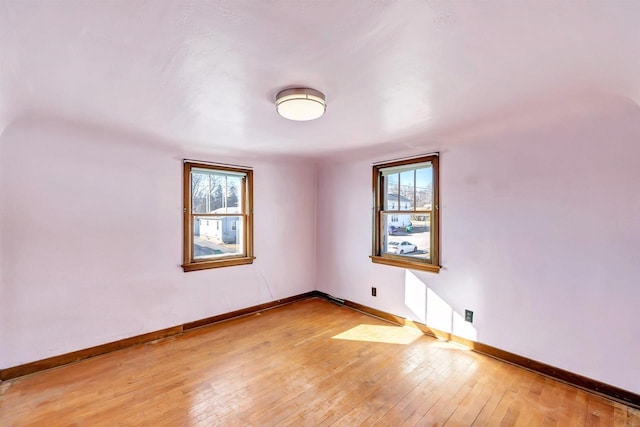 spare room with wood-type flooring