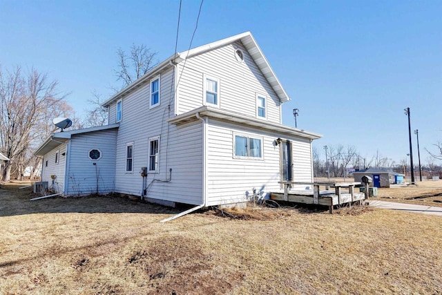 back of house with a lawn