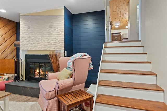 865 Richmond Way, Nekoosa, WI 54457 - staircase featuring wood finished floors, a glass covered fireplace, recessed lighting, and wooden walls