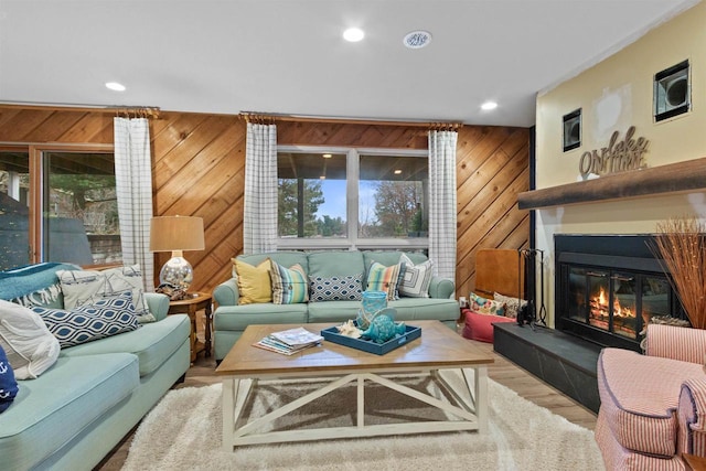 865 Richmond Way, Nekoosa, WI 54457 - living area featuring wooden walls, recessed lighting, wood finished floors, and a glass covered fireplace