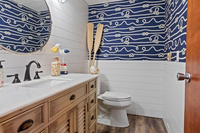 865 Richmond Way, Nekoosa, WI 54457 - half bath featuring wood finished floors, toilet, vanity, and wooden walls