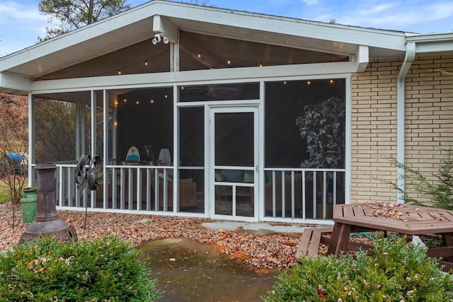 865 Richmond Way, Nekoosa, WI 54457 - back of house with a sunroom and brick siding